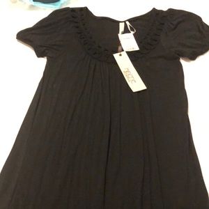 Black, short sleeve tunic, type top with detail around neck line. never worn.